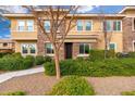Tan two-story townhome with stone accents and landscaping at 5550 N 16Th St # 102, Phoenix, AZ 85016