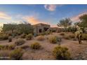 Luxury home nestled on a hillside with desert landscaping at 9950 E Sundance Trl, Scottsdale, AZ 85262