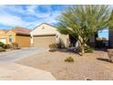 House exterior with a two-car garage and desert landscaping at 10436 W Payson Rd, Tolleson, AZ 85353