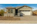 Single story house with a white garage door and stone accents at 10838 W Buchanan St, Avondale, AZ 85323