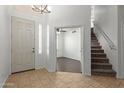 Inviting entryway with tile flooring, white walls, and staircase to the second floor at 12739 W Merrell St, Avondale, AZ 85392