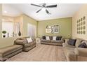 Spacious living room with neutral carpeting and a ceiling fan at 1650 S Crismon Rd # 69, Mesa, AZ 85209