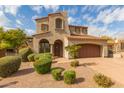 Two-story home with Spanish-style architecture,landscaped yard, and a two car garage at 18196 N 92Nd St, Scottsdale, AZ 85255