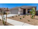 Inviting single-Gathering home with a well-kept lawn and attractive desert landscape featuring new trees and shrubbery at 18366 W Poston Dr, Surprise, AZ 85387