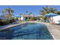 Inviting swimming pool with blue umbrellas and comfortable lounge chairs at 18825 N 40Th Pl, Phoenix, AZ 85050