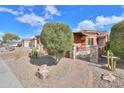 Landscaped front yard with a brick pathway and metal gate at 22 S Mesilla Ln, Casa Grande, AZ 85194