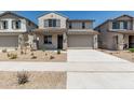 Attractive two-story home with a two-car garage, covered porch, and desert-friendly front yard landscaping at 22831 N 183Rd Dr, Surprise, AZ 85387