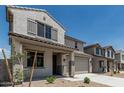 Desirable two-story home with a two-car garage, covered entrance, and low-water landscaping at 22831 N 183Rd Dr, Surprise, AZ 85387