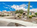 One-story house with a two-car garage, landscaping, and a tall saguaro cactus at 26689 W Burnett Rd, Buckeye, AZ 85396