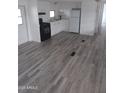 Open living area with grey flooring and access to kitchen at 303 S Recker Rd # 126, Mesa, AZ 85206