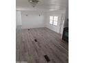 Large living room featuring light grey wood-look flooring at 303 S Recker Rd # 126, Mesa, AZ 85206
