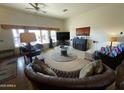 Relaxing living room with a fireplace and large screen TV at 30508 N 239Th Dr, Wittmann, AZ 85361