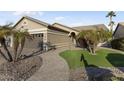 Tan house with landscaped yard and walkway at 3171 N 159Th Ave, Goodyear, AZ 85395