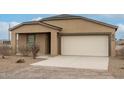 Tan house with a white garage door and landscaping at 3715 N Algodon Dr, Eloy, AZ 85131