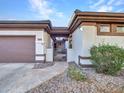Front entry with iron gate and stone pathway at 41933 N Crooked Stick Rd, Anthem, AZ 85086