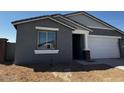 The home's front with a two-car garage, neutral stucco, and a simple, clean aesthetic at 4353 E Bradford Ave, San Tan Valley, AZ 85140