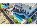 Aerial view of a house with a pool and a backyard at 4628 W Hasan Dr, Laveen, AZ 85339