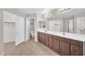Bright bathroom featuring a double vanity, tile floors, and ample closet space at 4628 W Hasan Dr, Laveen, AZ 85339