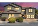 Two-story house with a landscaped front yard and double garage at 4628 W Hasan Dr, Laveen, AZ 85339
