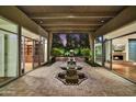 Brick courtyard with central fountain, surrounded by glass doors at 5652 N Scottsdale Rd, Paradise Valley, AZ 85253