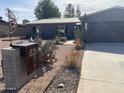 Single story home with gray exterior, landscaped yard, and a modern design at 6307 E Gelding Dr, Scottsdale, AZ 85254