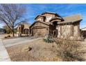 Two-story house with a brown facade, driveway, and desert landscaping at 728 E Lovegrass Dr, San Tan Valley, AZ 85143