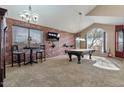 Game room featuring a pool table and brick feature wall at 9348 E Grandview St, Mesa, AZ 85207