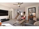 Open living area with high ceilings, staircase, and large TV at 9573 E Dreyfus Pl, Scottsdale, AZ 85260