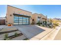 Contemporary home exterior showcasing a clean design and spacious driveway at 12451 E Troon Vista Dr, Scottsdale, AZ 85255