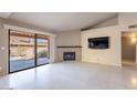Bright living room featuring a fireplace and sliding glass doors to a patio at 14637 N Olympic Way, Fountain Hills, AZ 85268