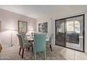 Charming dining area with a glass table and four chairs at 15225 N 100Th St # 1208, Scottsdale, AZ 85260