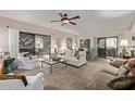 Spacious living room with ample seating and a ceiling fan at 15225 N 100Th St # 1208, Scottsdale, AZ 85260