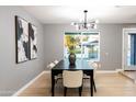 Elegant dining room with a large table and statement lighting fixture at 1743 W Butler Dr, Phoenix, AZ 85021