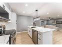 Modern kitchen boasting white cabinetry, quartz countertops, and stainless steel appliances at 1743 W Butler Dr, Phoenix, AZ 85021
