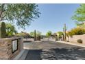 Gated entrance to a community with desert landscaping and well-maintained streets at 20750 N 87Th St # 1009, Scottsdale, AZ 85255