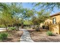 Community grounds feature mature desert landscaping, walking paths and mature trees at 20750 N 87Th St # 1009, Scottsdale, AZ 85255