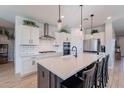 Modern kitchen with white cabinets, quartz countertops, and stainless steel appliances at 22633 E Domingo Rd, Queen Creek, AZ 85142