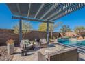 Relaxing backyard oasis with a sparkling pool and pergola at 22633 E Domingo Rd, Queen Creek, AZ 85142