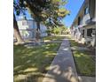 Landscaped courtyard with a shaded walkway and seating area at 2545 W Rose Ln # A-2, Phoenix, AZ 85017