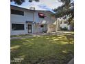 Neatly kept townhouse with a manicured lawn and shaded walkway at 2545 W Rose Ln # A-2, Phoenix, AZ 85017
