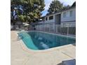 Community pool with surrounding patio and seating area at 2545 W Rose Ln # A-2, Phoenix, AZ 85017