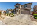 Two-story house with tan exterior, two-car garage, and landscaping at 26049 S 230Th St, Queen Creek, AZ 85142