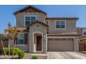Two-story house with tan exterior, two-car garage, and landscaping at 26049 S 230Th St, Queen Creek, AZ 85142