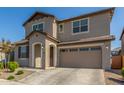 Two-story house with tan exterior, two-car garage, and landscaping at 26049 S 230Th St, Queen Creek, AZ 85142