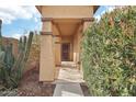 Covered entryway with a security door and desert landscaping at 3376 S 256Th Dr, Buckeye, AZ 85326