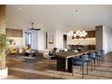 Open concept living and dining area with hardwood floors and modern light fixtures at 3832 E Highland Ave, Phoenix, AZ 85018