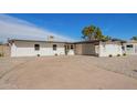 This home features a spacious driveway, desert landscaping, and a covered parking area at 5528 W Sunnyslope Ln, Glendale, AZ 85302