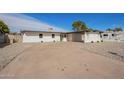 This home features a spacious driveway, desert landscaping, and a covered parking area at 5528 W Sunnyslope Ln, Glendale, AZ 85302