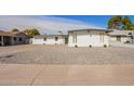 Charming white brick home featuring desert landscaping and a contemporary design at 5528 W Sunnyslope Ln, Glendale, AZ 85302