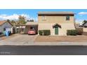 Two-story home with a covered parking area and small, well-maintained front yard bushes at 8328 W Fairmount Ave, Phoenix, AZ 85037